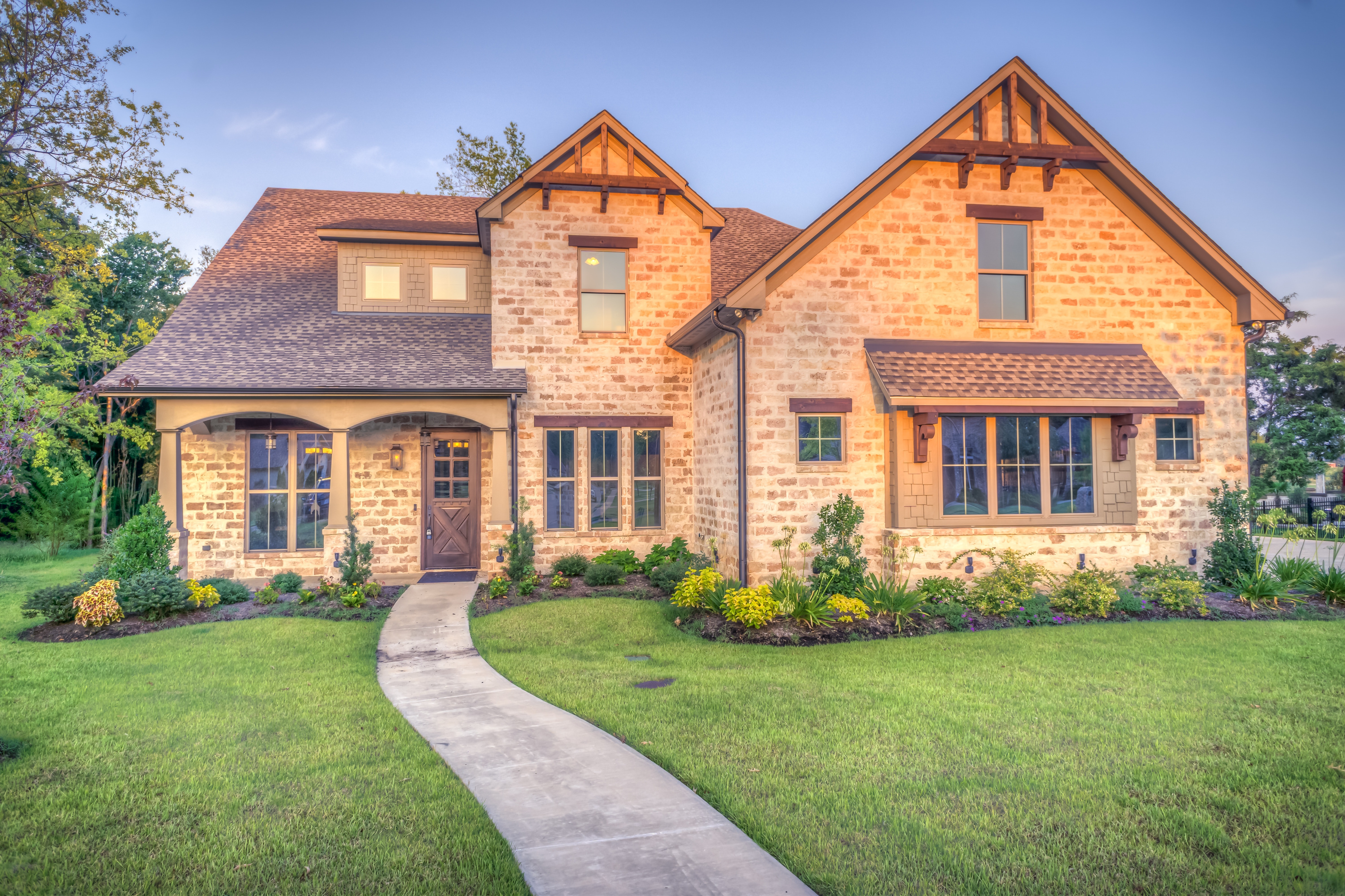 House with walkway across a green lawn