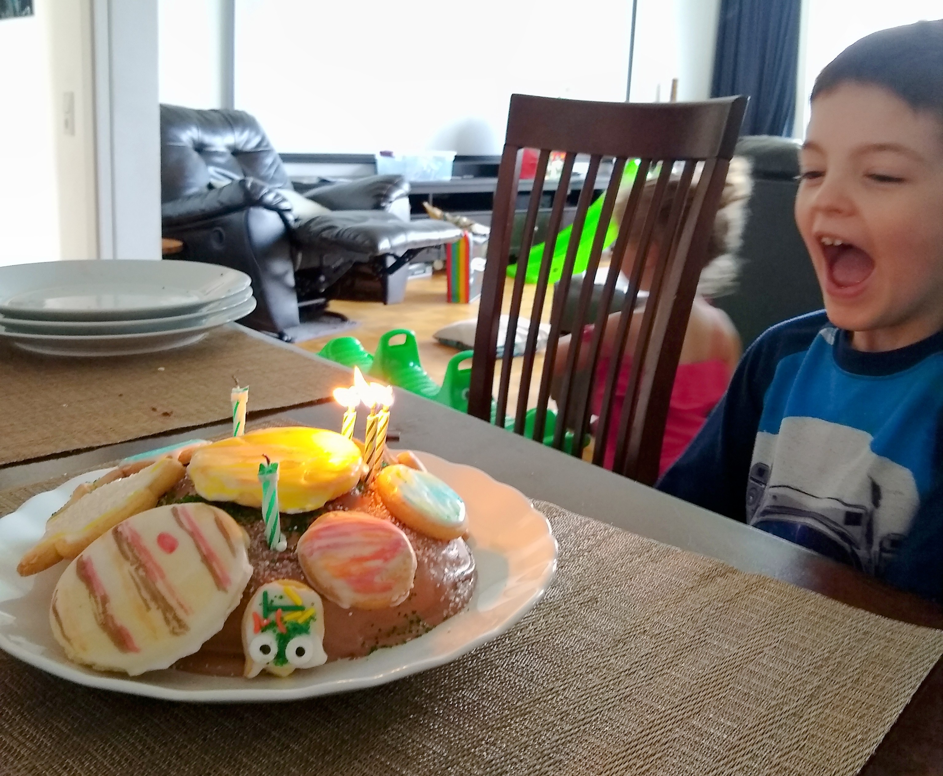 child blowing out birthday candles 